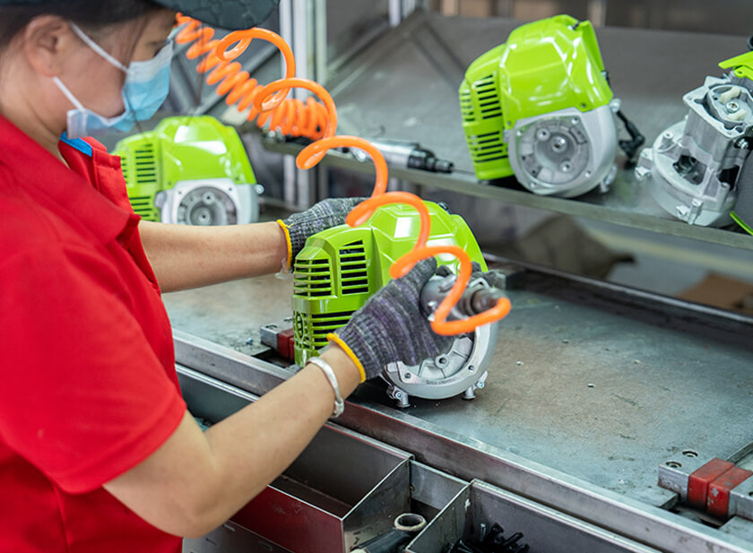 Trabalhadores estão montando motores de máquinas de jardim