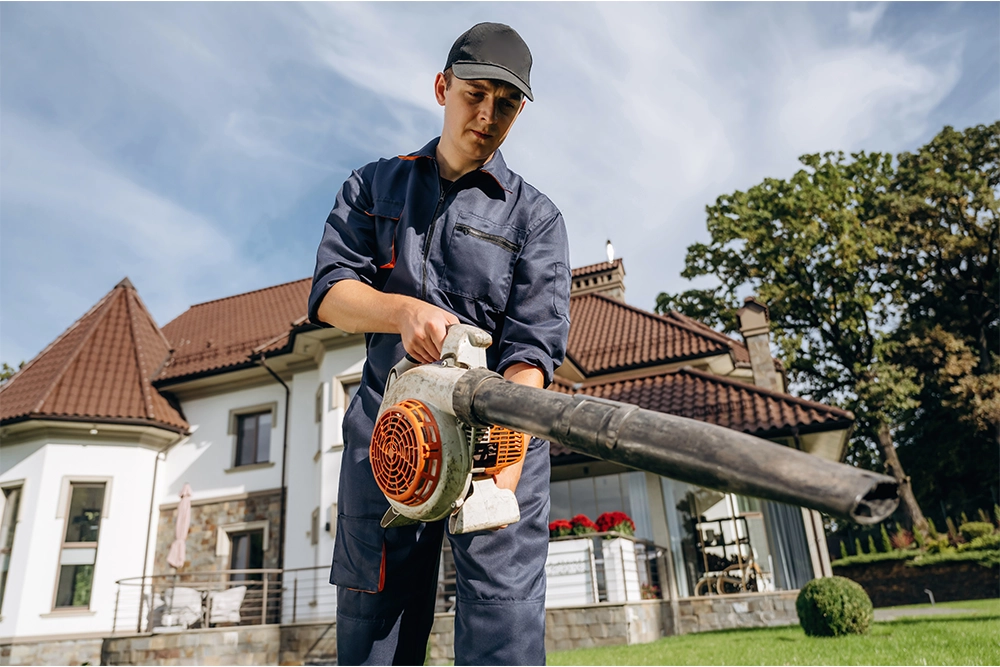 3cleaning gutters with a leaf blower