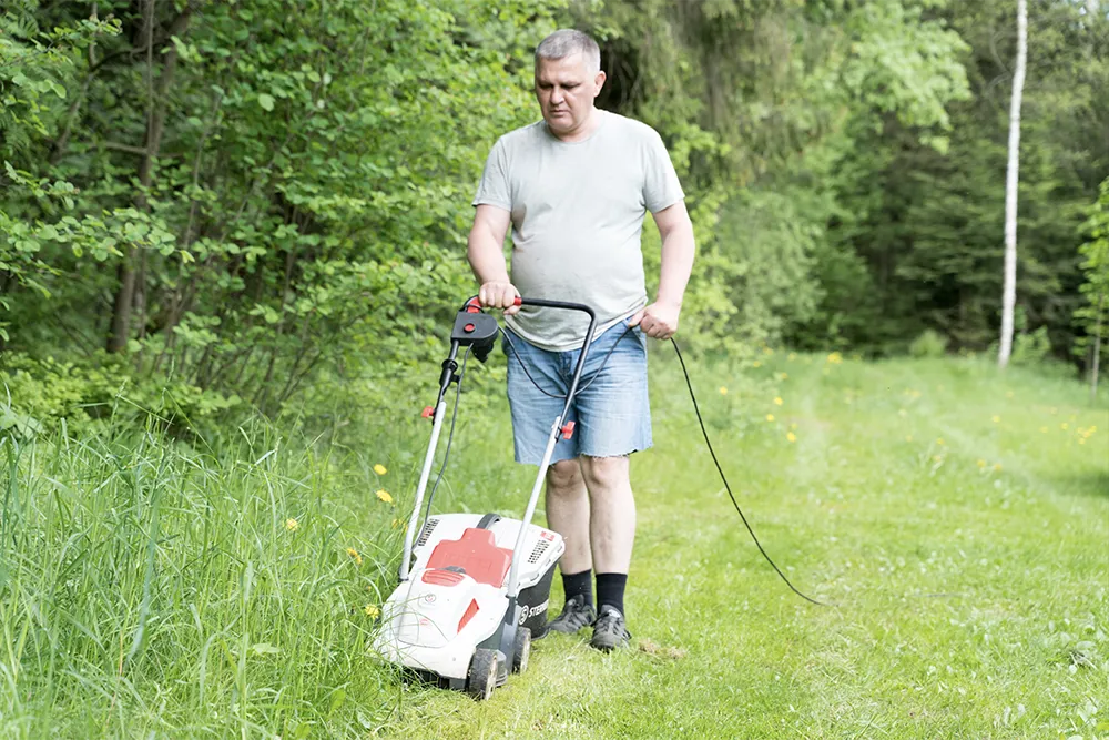 4.one person using an electric lawnmower