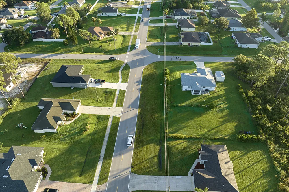 5.a typical street scene in an american suburban community, with every house having a lawn.